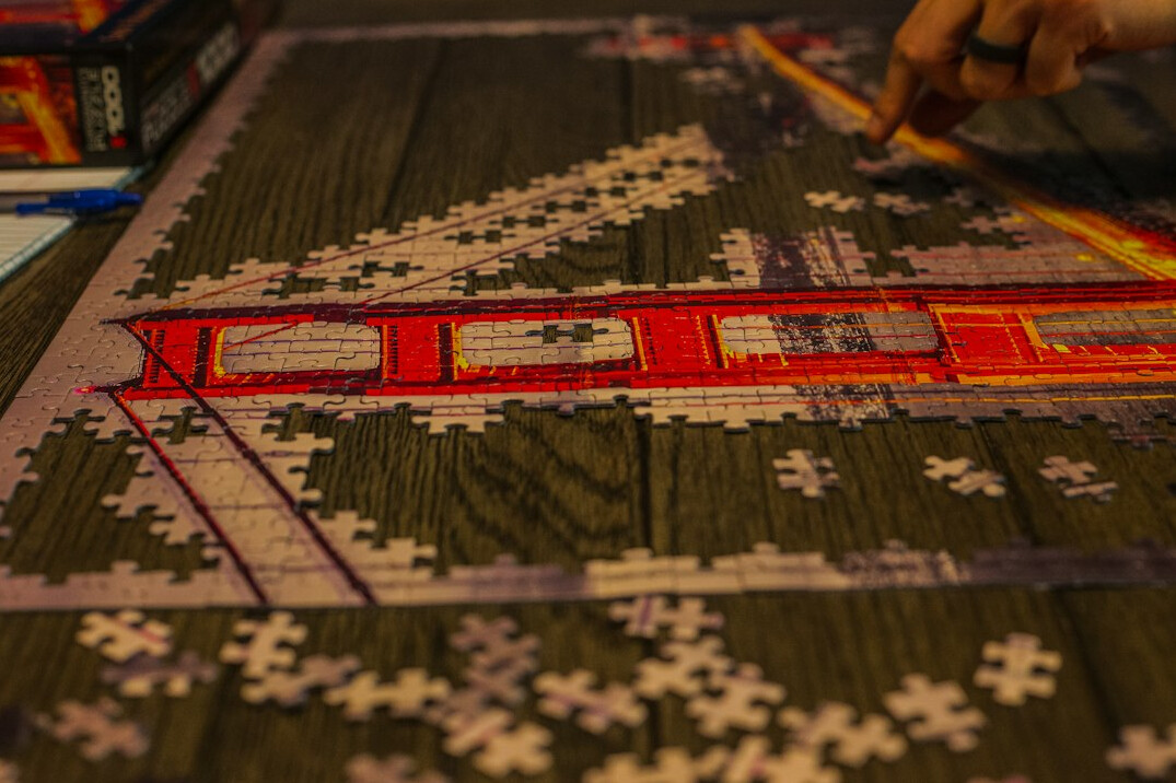 person solving puzzle on paper